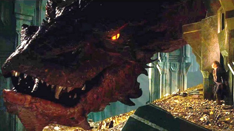 Smaug (Benedict Cumberbatch) peers closely at Bilbo Baggins (Martin Freeman) in The Hobbit: The Desolation of Smaug