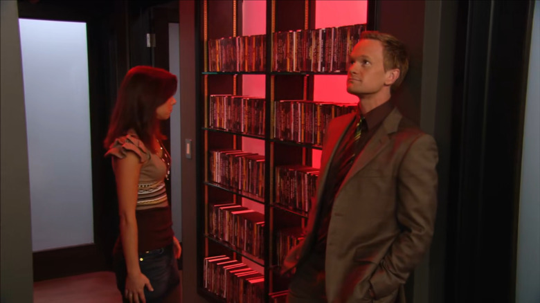 Barney Stinson (Neil Patrick Harris) shows Lily Aldrin (Alyson Hannigan) his professionally-lit porn collection in How I Met Your Mother