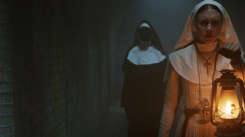 taissa farmiga the nun holds lantern