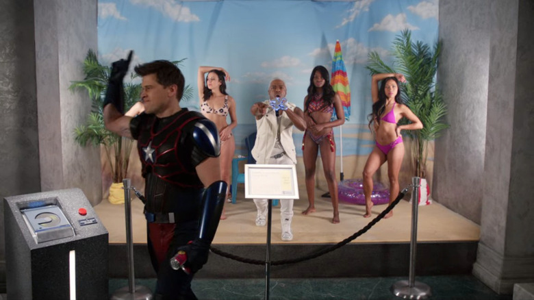 Nate presses play on a museum display to play "The Thong Song" in the "Legends of Tomorrow" episode "Swan Thong"