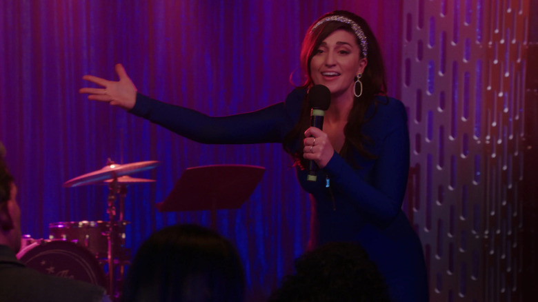 Dawn (Sara Bareilles) sings for the crowd in Girls5Eva