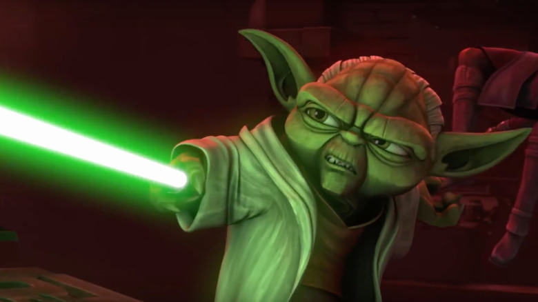 Yoda (Tom Kane) brandishes a lightsaber in Star Wars: The Clone Wars