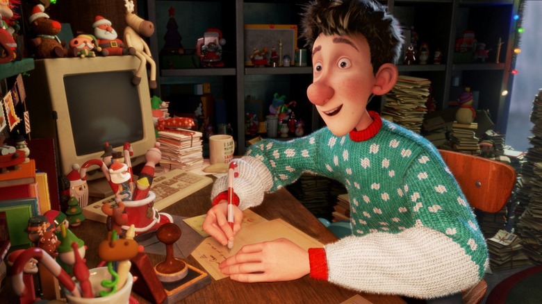 Arthur Claus writing at desk