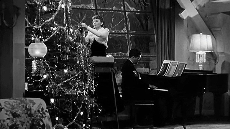 Elizabeth Lane decorating tree; Jones playing piano
