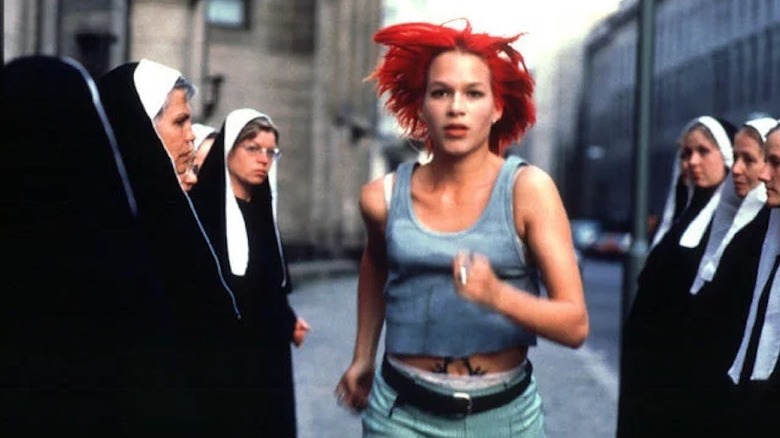 Red-haired Lola running past group of nuns in Run Lola Run