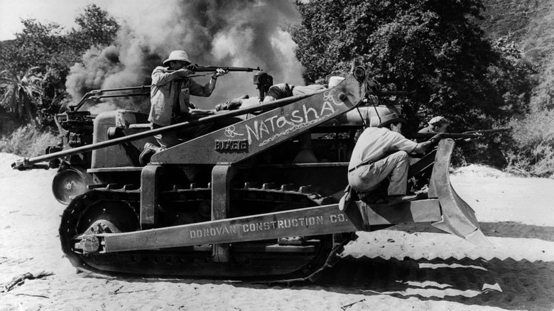 Donovan (John Wayne) rides a bulldozer in The Fighting Seabees