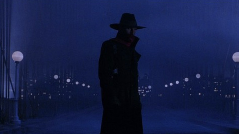 The Shadow (Alec Baldwin) patrols a bridge in The Shadow