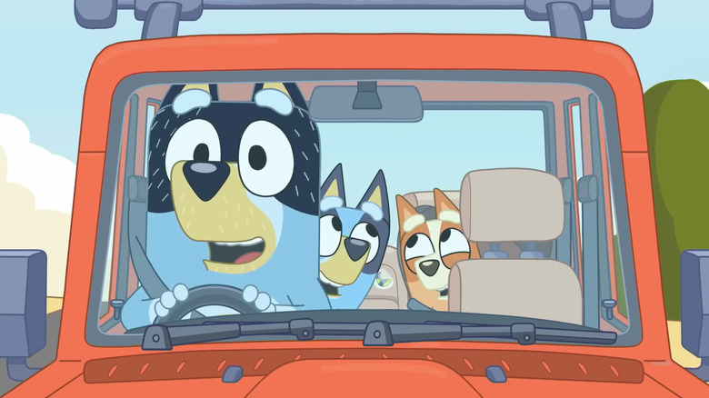 Bandit (David McCormack) drives his children Bluey and Bingo in Bluey