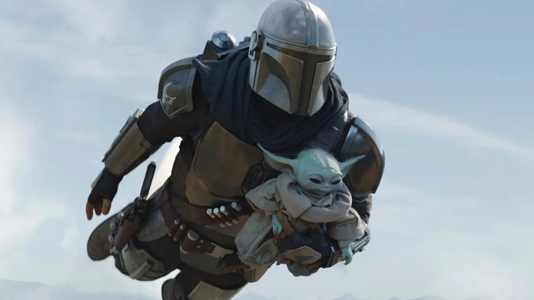 The Mandalorian (Pedro Pascal) flies with Grogu in The Mandalorian