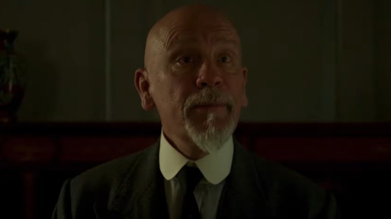 John Malkovich as Hercule Poirot with his eyebrows raised on The ABC Murders