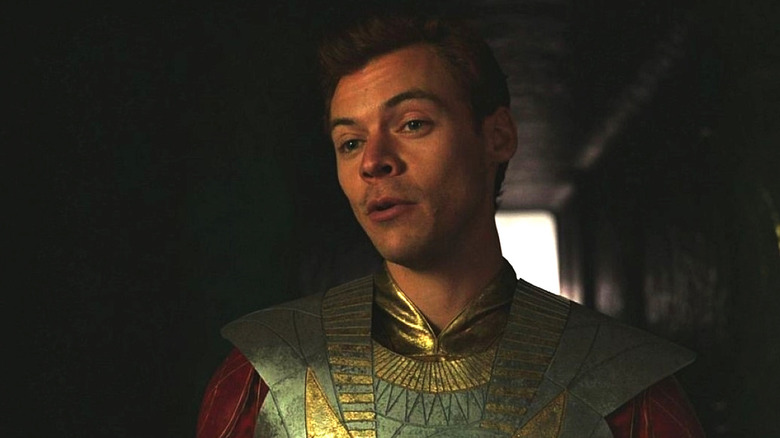 Harry Styles as Starfox stands in a hallway in Eternals