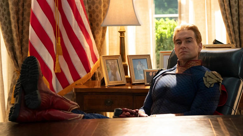Homelander (Antony Starr) sits in the Oval Office with his boots on the presidential desk in The Boys