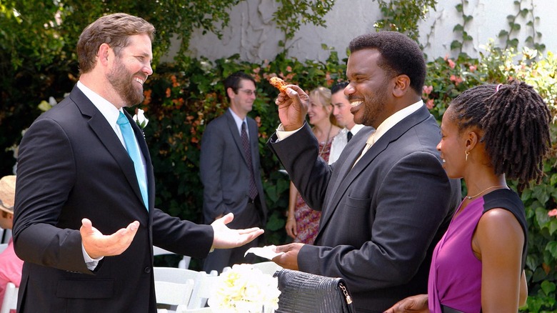 David Denman, Craig Robinson, and Ammenah Kaplan as Roy, Daryl, and Val, enjoying the reception at Roy's wedding on The Office