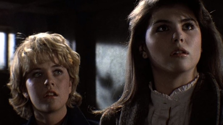 Lisa (Meg Ryan) and Susan (Lori Loughlin) looking up in Amityville 3-D