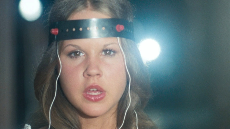Regan MacNeil (Linda Blair) wearing a head device in Exorcist II: The Heretic