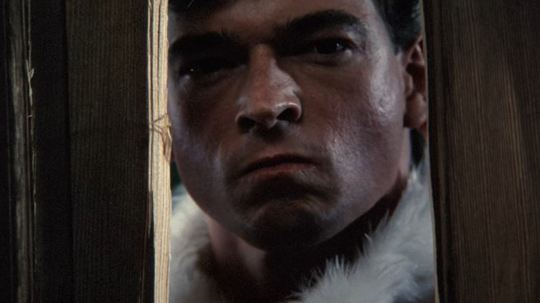 Ricky Chapman (Eric Freeman) looking through broken door in Silent Night, Deadly Night Part 2