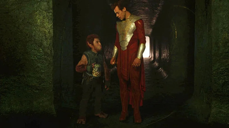 Pip the Troll (Patton Oswalt) and Eros (Harry Styles) glance at each other in a hallway in Eternals