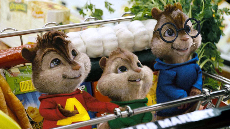 Justin Long as Alvin, Matthew Gray Gubler as Simon, and Jesse McCartney as Theodore in Alvin and the Chipmunks, sitting in a shopping cart with groceries looking up at somebody.