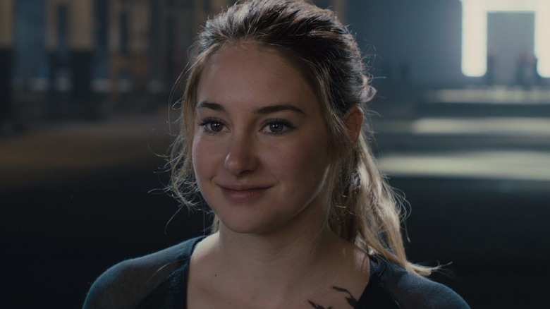 Shailene Woodley as Beatrice "Tris" Prior in Divergent, smiling at someone past the camera.