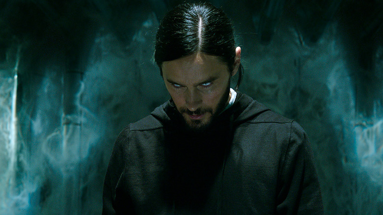 Jared Leto as Dr. Michael Morbius in Morbius, staring down toward the ground with glowing eyes.