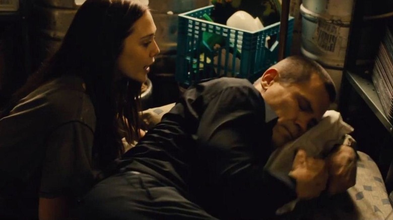 Joe (Josh Brolin) resting on a pillow while Marie (Elizabeth Olsen) watches in 2013's Oldboy