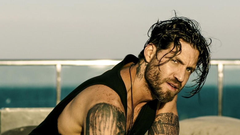 Bodhi (Edgar Ramirez) crouched over in 2015's Point Break