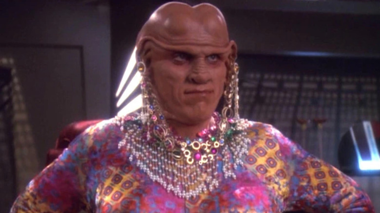 Quark (Armin Shimerman) stands disguised as a woman in Star Trek: Deep Space Nine