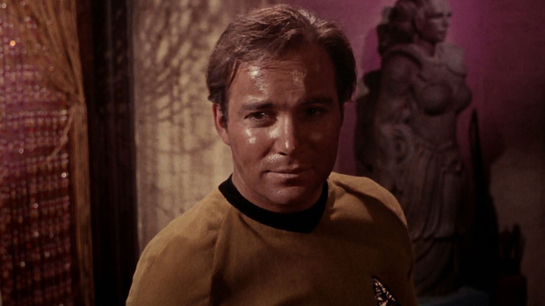 A disheveled Jim Kirk (William Shatner) stands smirking in Star Trek: The Original Series