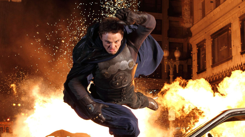 David Lyons as Vince Faraday, jumping away from an explosion in The Cape