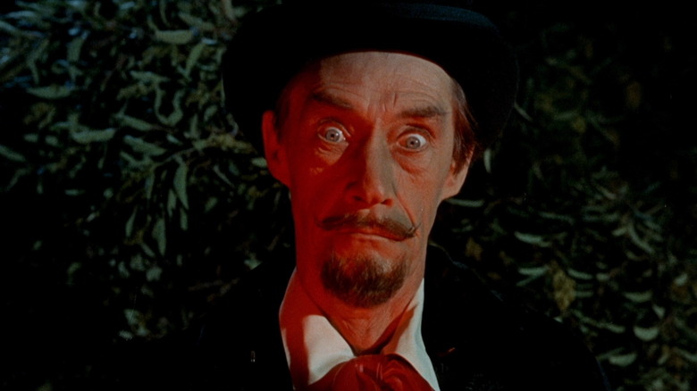 Dracula (John Carradine) stands wide-eyed in a red light in Billy the Kid Versus Dracula