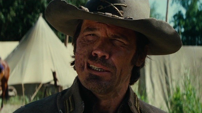 Jonah Hex (Josh Brolin) stands scarred in a camp in Jonah Hex