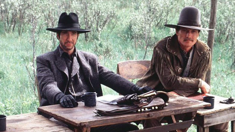 Leander McNelly (Dylan McDermott) and John Armstrong (Robert Patrick) sit at a table in Texas Rangers