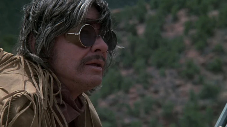 Wild Bill Hickock (Charles Bronson) looks up wearing sunglasses in The White Buffalo