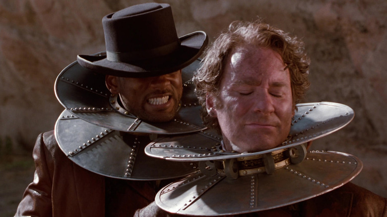 Jim West (Will Smith) and Artemus Gordon (Kevin Kline) are stuck together by magnetic disks around their necks in Wild Wild West