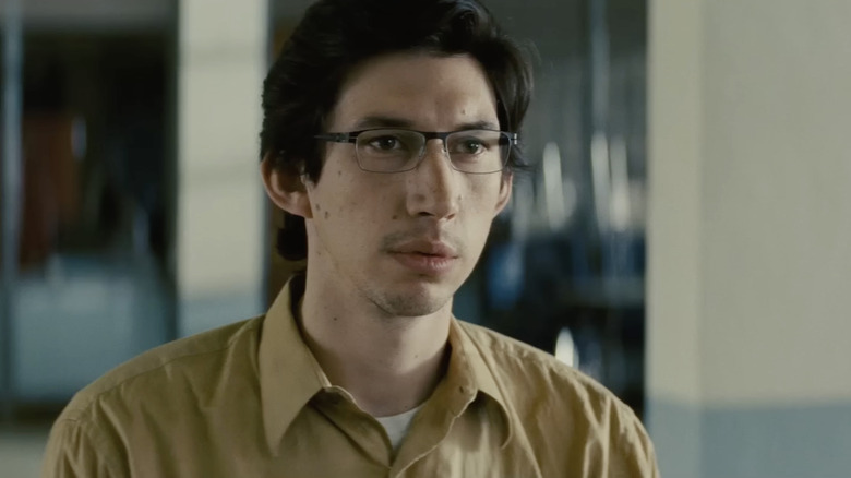 Adam Driver as Sevier sitting at a table in Midnight Special