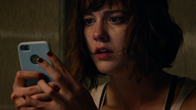 Michelle looking at her phone in 10 Cloverfield Lane