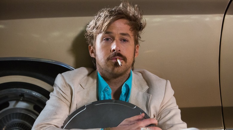 Disheveled Ryan Gosling smoking