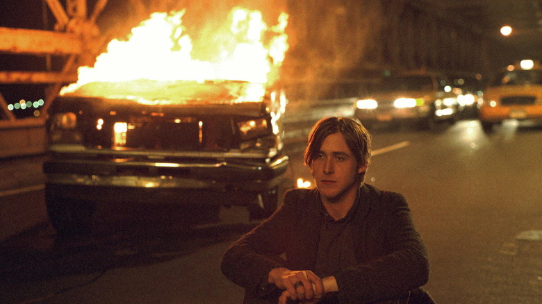 Ryan Gosling with burning car
