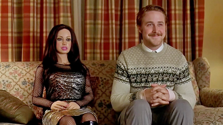 Ryan Gosling smiling with life-size doll