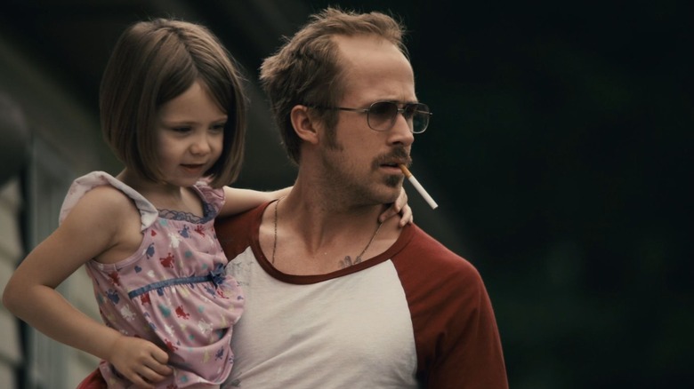 Ryan Gosling smoking and holding child