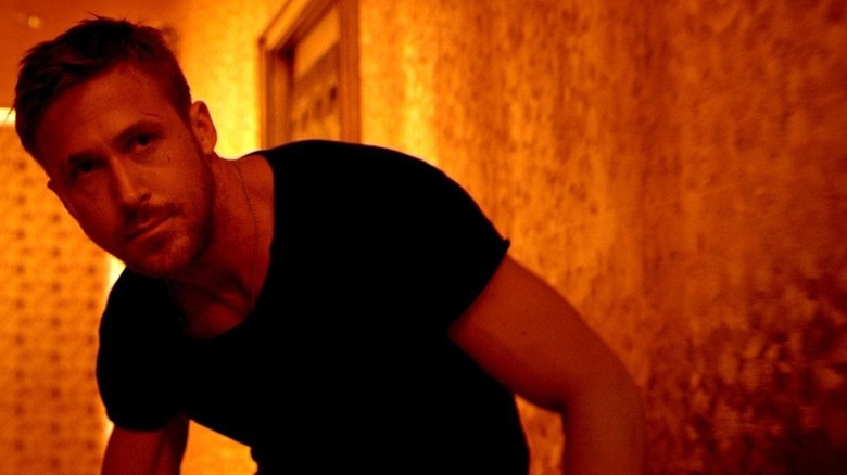 Ryan Gosling in neon hotel corridor