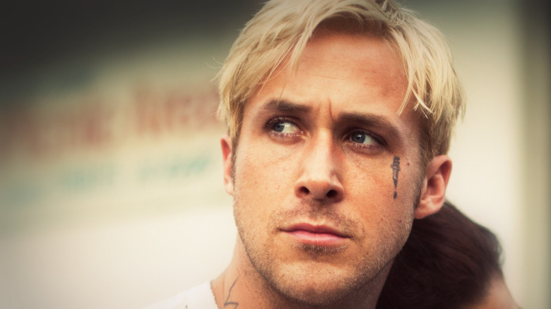 Tattooed Ryan Gosling with bleached hair