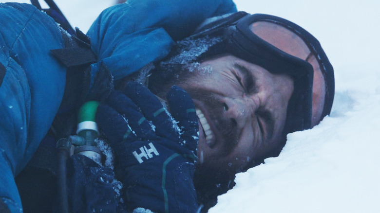 Jake Gyllenhaal's Scott Fischer grimaces as he lays in snow in Everest