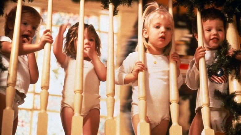 Four toddler standing behind wooden railing in Baby Geniuses