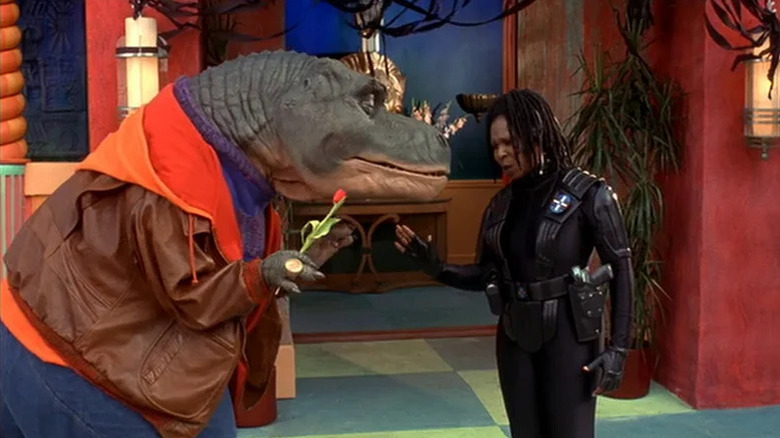 Whoopi Goldberg standing next to a T-Rex wearing clothes in Theodore Rex