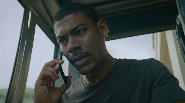 Terry Richmond (Aaron Pierre) answers the phone in Rebel Ridge (2024)