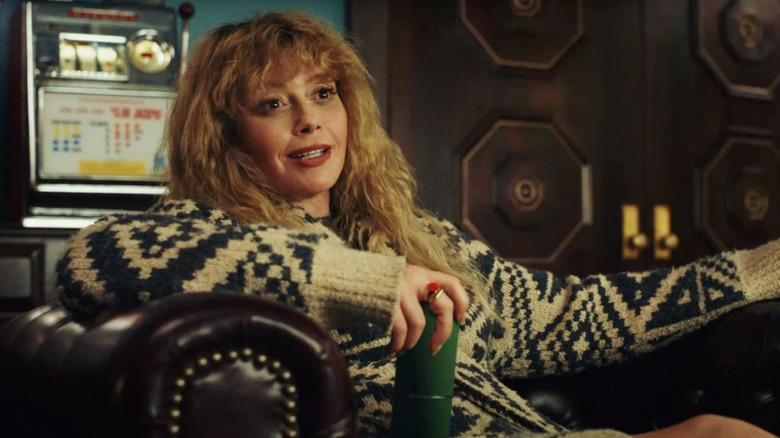 Charlie Cale (Natasha Lyonne) sitting in a chair in Poker Face (2021-present)