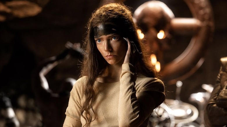 Anya Taylor-Joy as Furiosa painting her forehead in Furiosa: A Mad Max Saga
