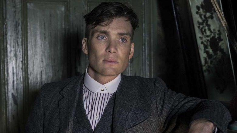 Cillian Murphy as Tommy Shelby looks contemplative in Peaky Blinders