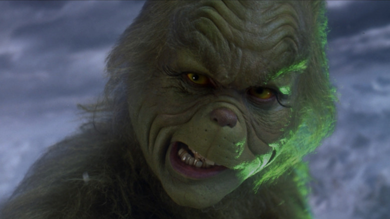 Jim Carrey as the Grinch looking at the camera in How the Grinch Stole Christmas
